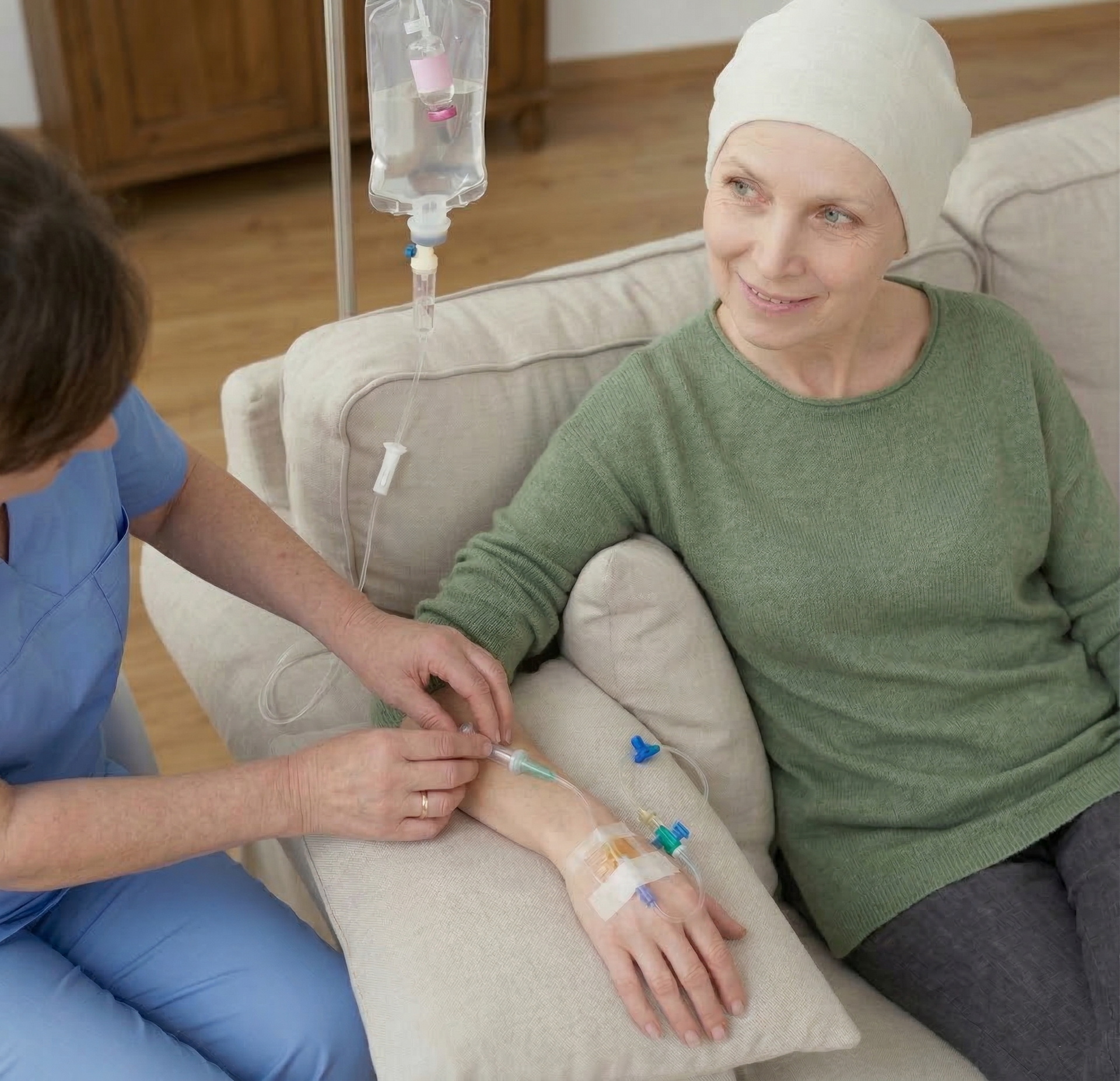AQUA MD Mobile IV Nurse administering IV therapy to a cancer patient resting on a couch at home