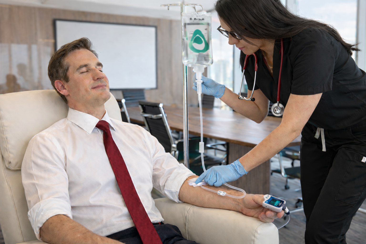 A man and a woman are sitting on a porch next to a lake.