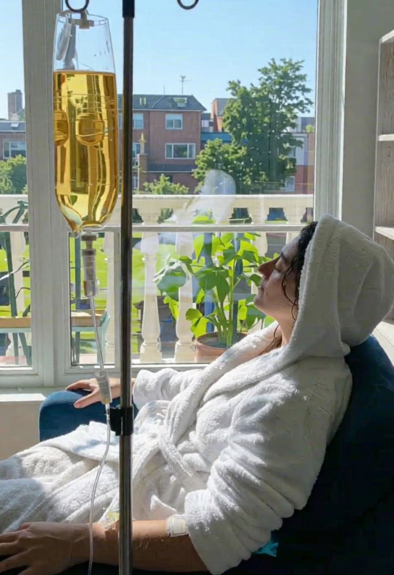 Woman receiving AQUA MD beauty IV infusion for skin hydration, collagen support, and overall wellness.