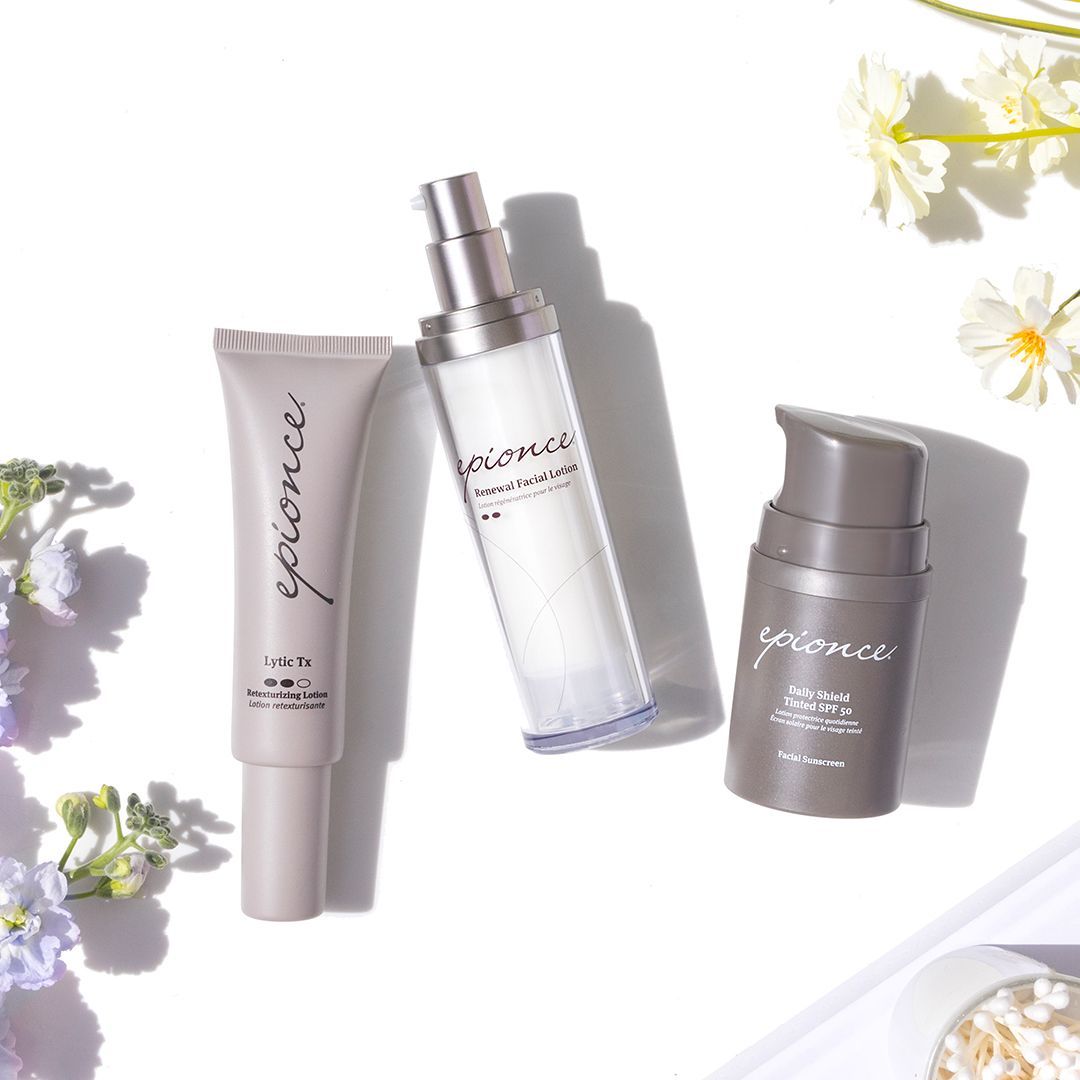 Three bottles of epionce cosmetics are sitting on a table