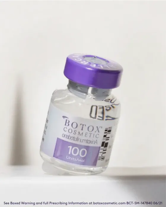 A bottle of botox cosmetic is sitting on a table.