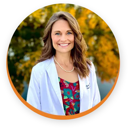 A woman in a white lab coat is smiling in a circle.