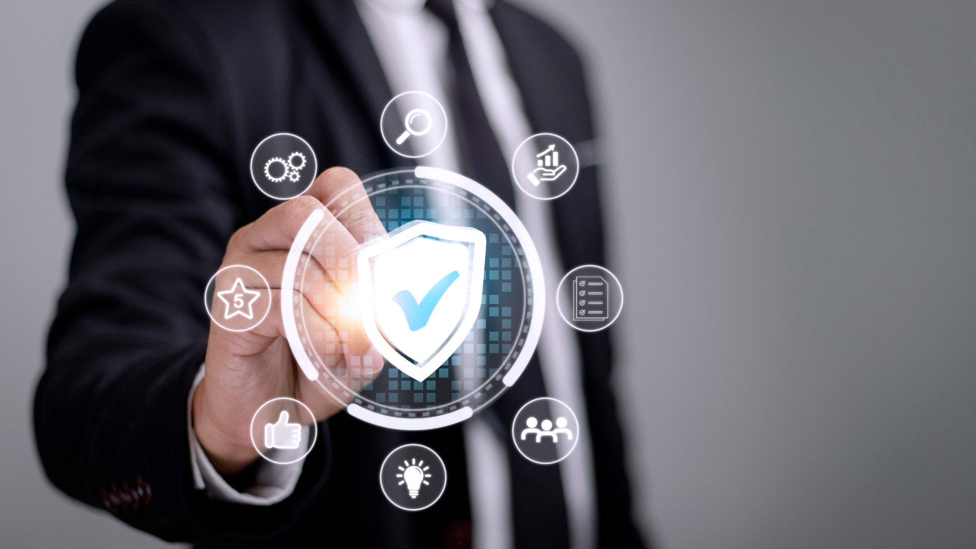 A man in a suit is pointing at a shield with a check mark on it.