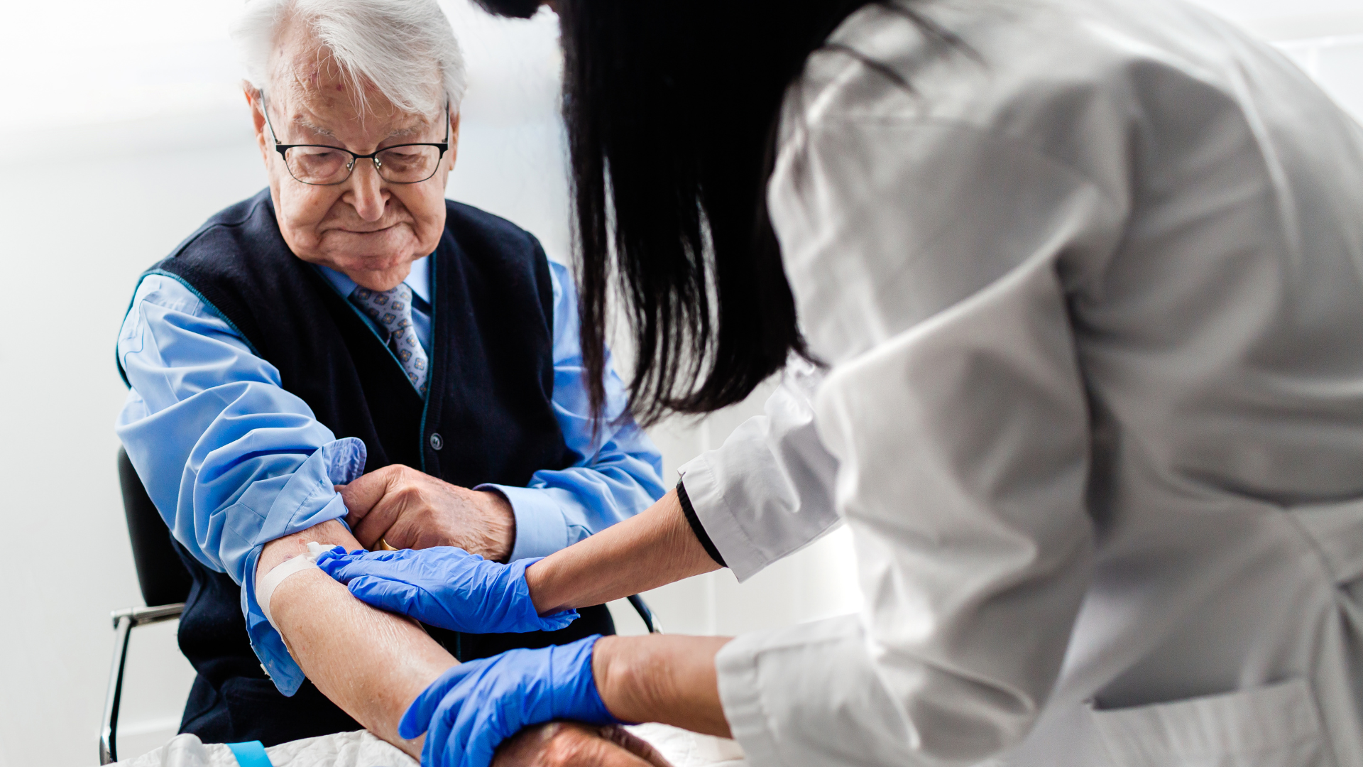 A provider carefully conducts a complete blood count test for a senior patient.