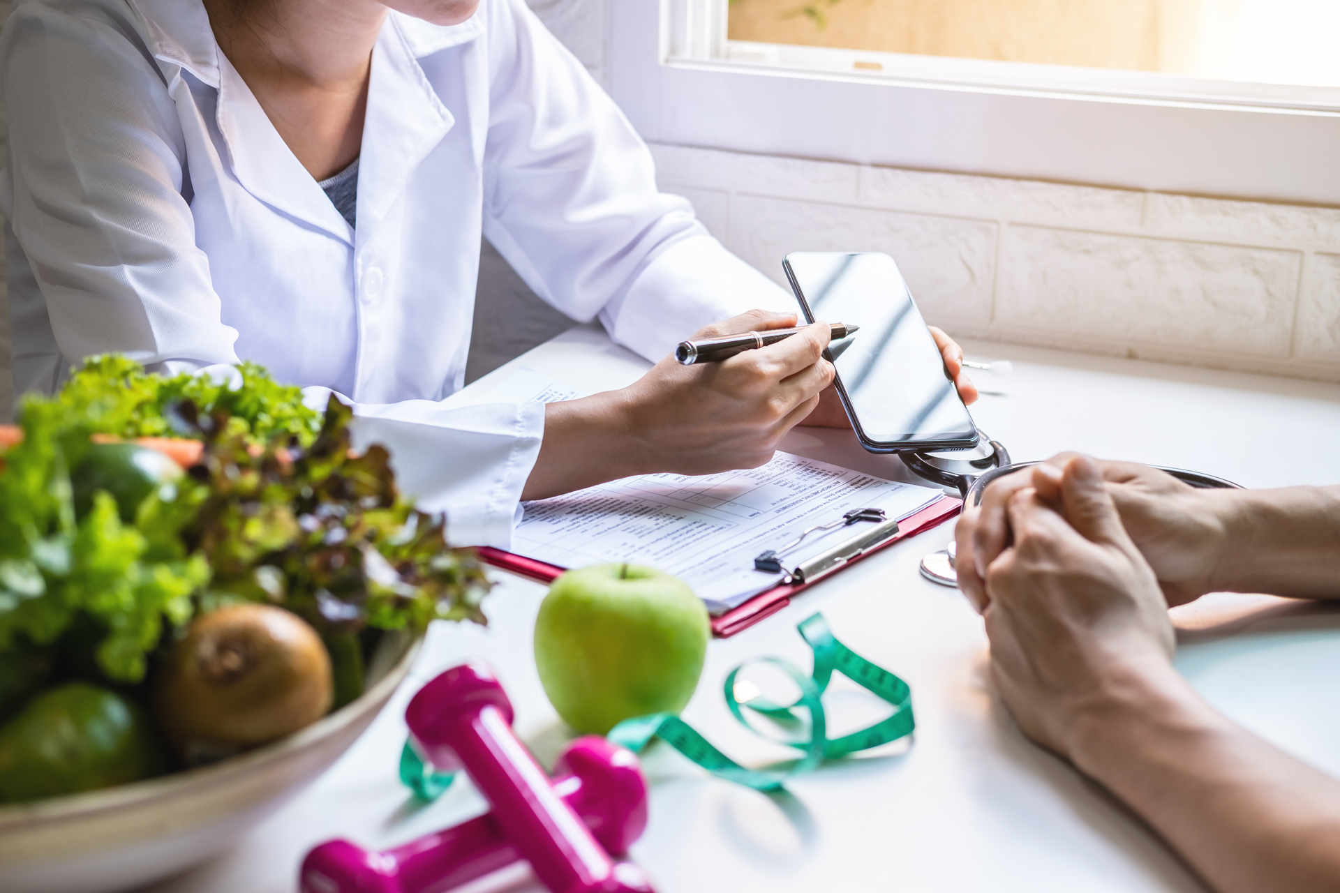 A doctor creating a wellness and diet plan for their senior client.