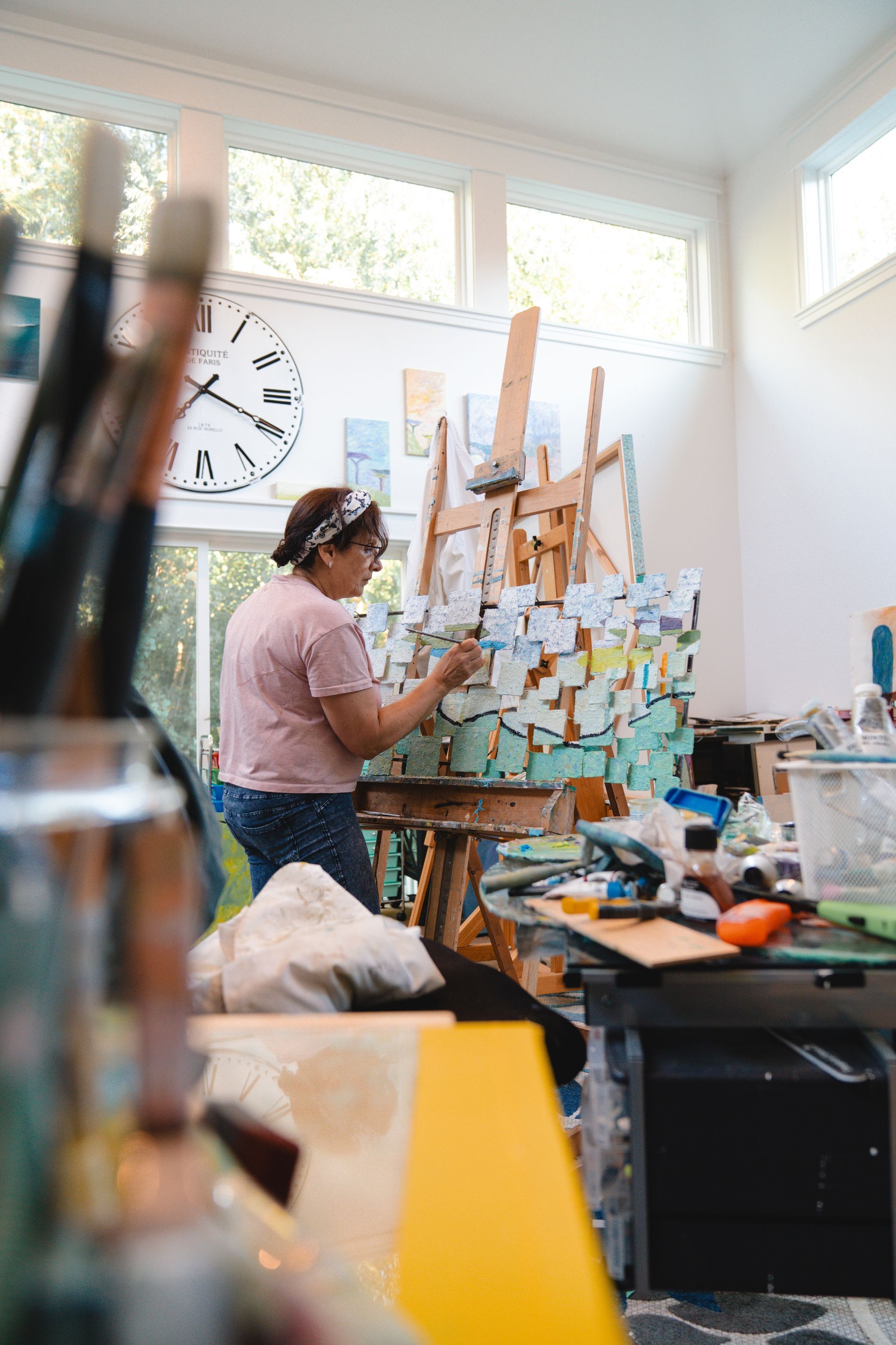 Layered mountain range silhouette under a vibrant, orange-yellow sunset sky.