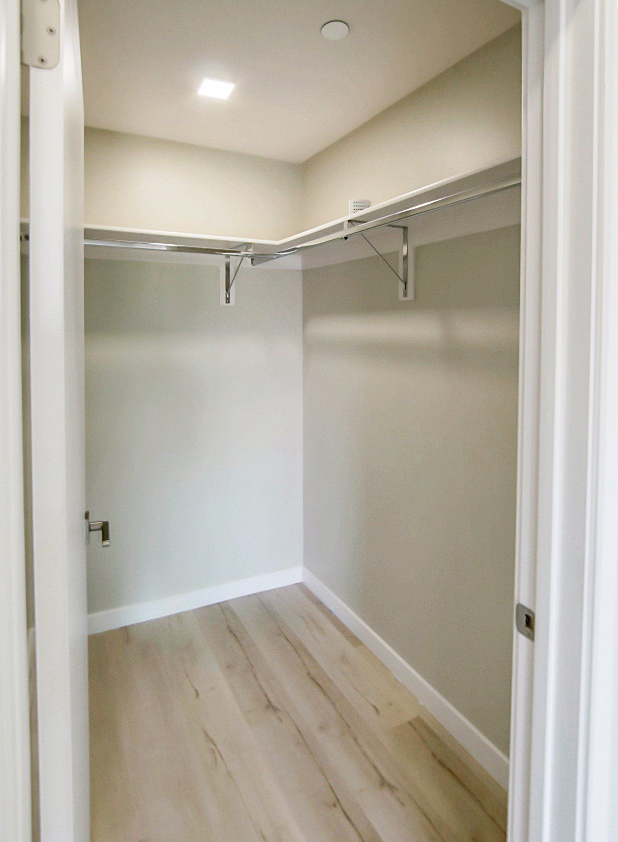 Walk-in closet with hardwood floors