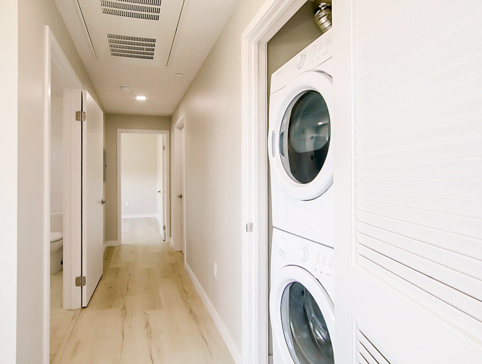 Stackable full size washer and dryer in unit.