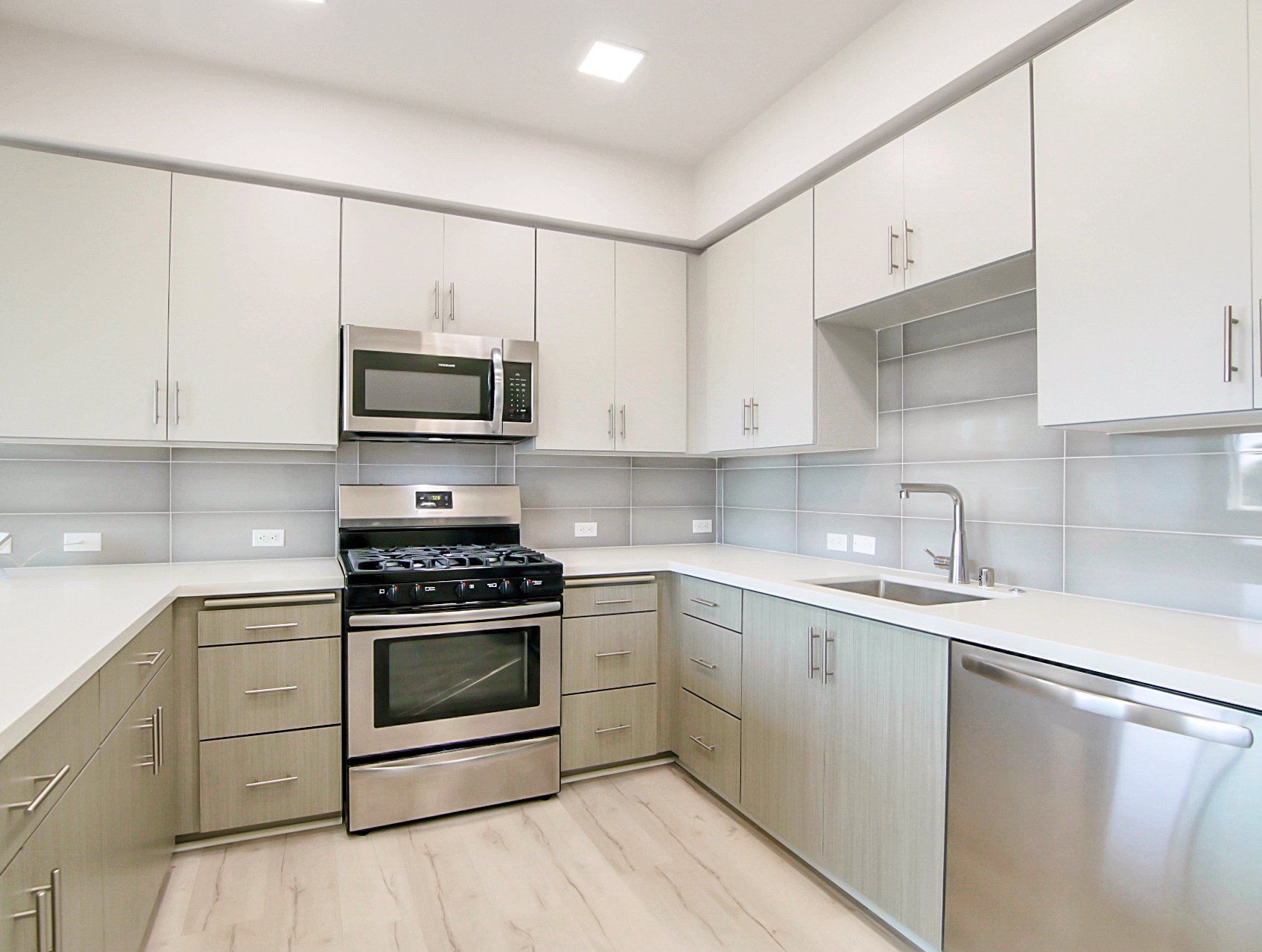 Modern kitchen with hardwood and stainless steel appliances