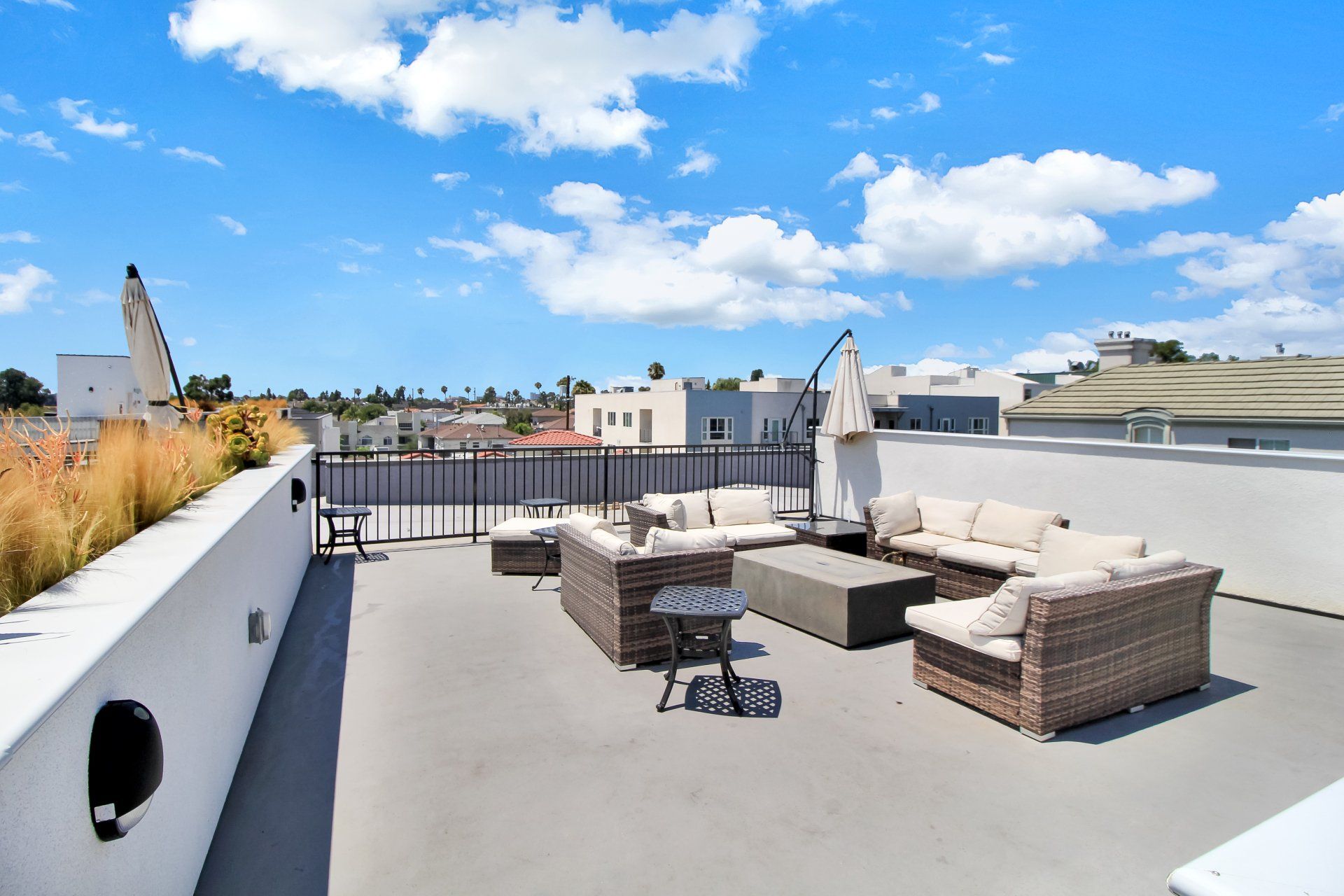 Rooftop deck with patio table and lounge seating.