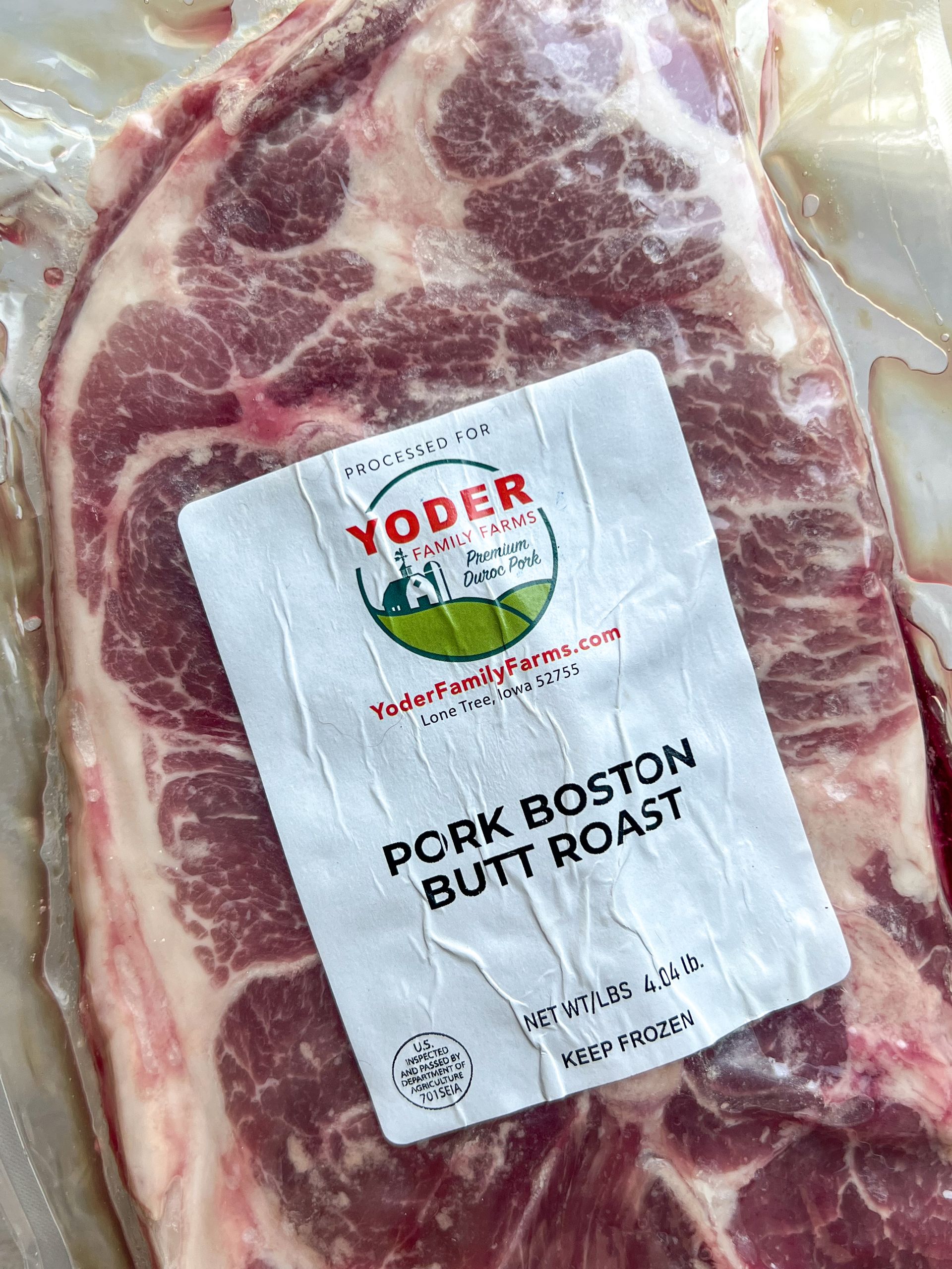 A package of pork boston butt roast is sitting on a table.