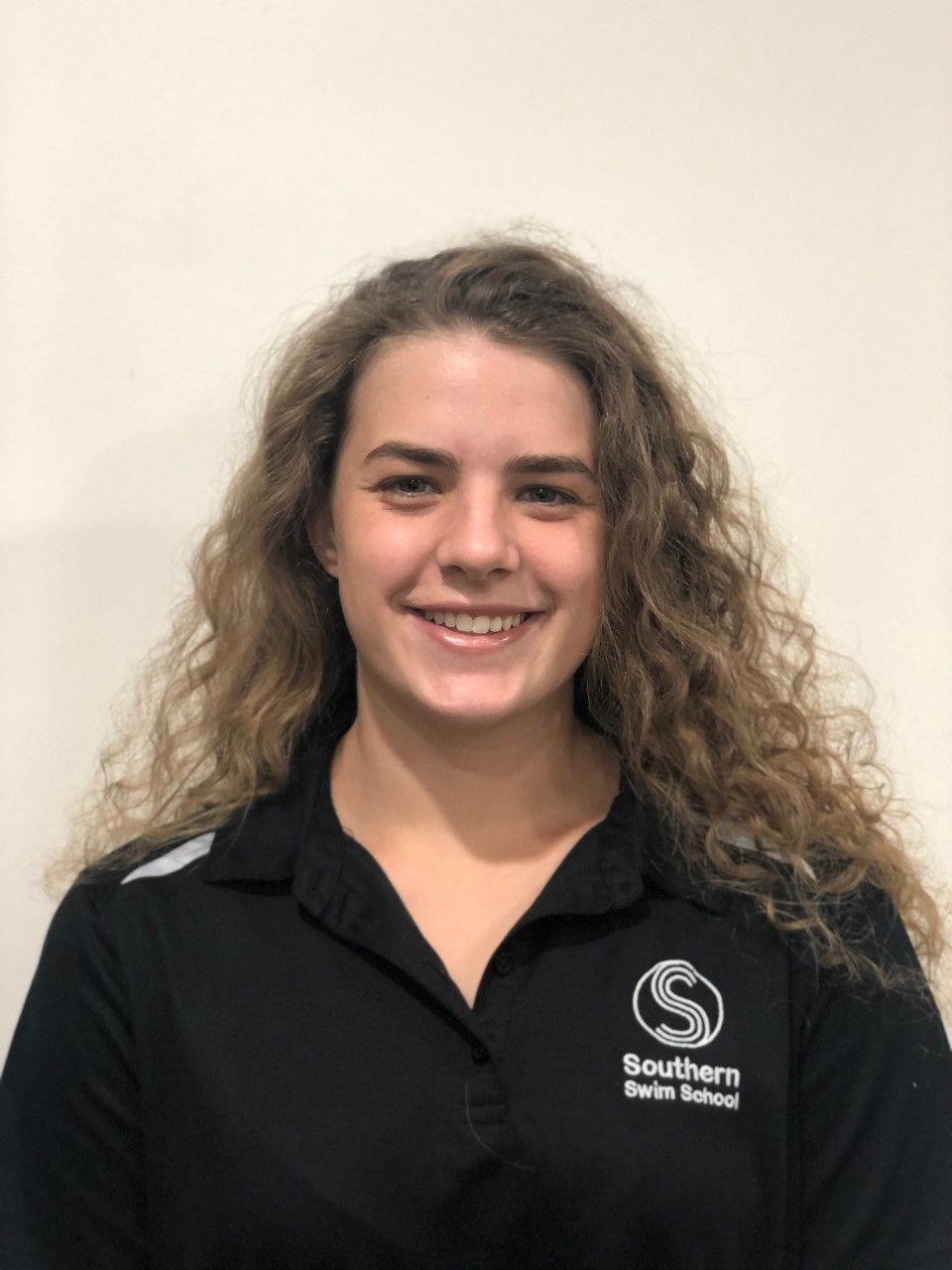 A woman wearing a black shirt that says southern swim school