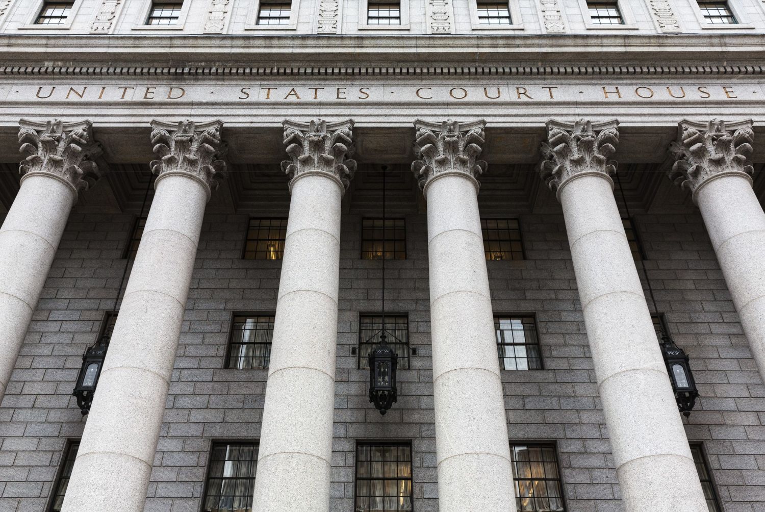 The front of a united states court building with columns