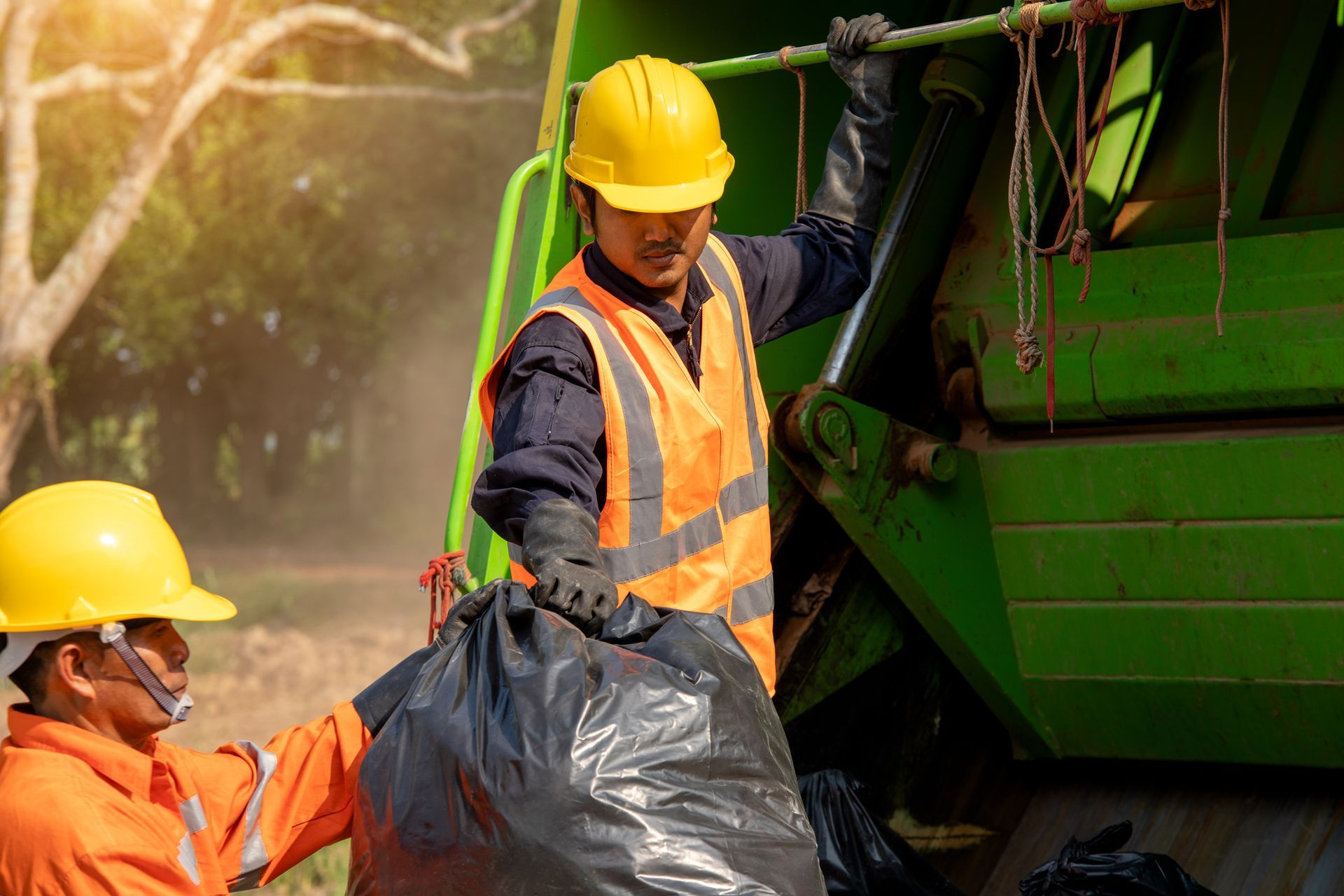 A pile of furniture is sitting on the side of the road in front of a building.