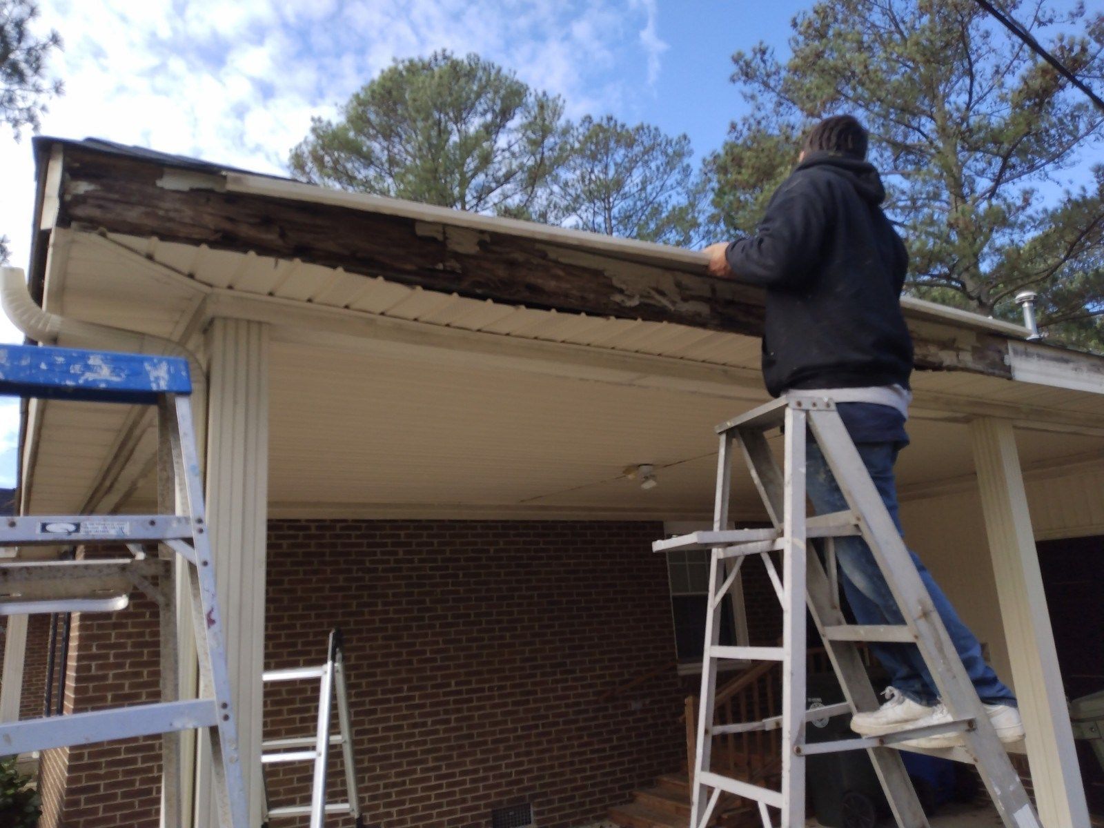 Workers replacing the wood rot