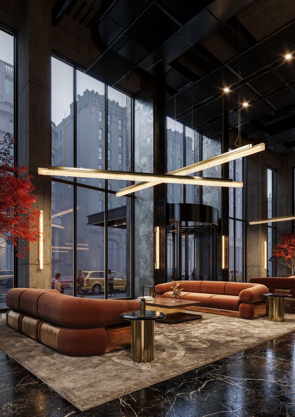 Lobby interior with large windows, red sofas, and a modern light fixture. A revolving door leads outside.