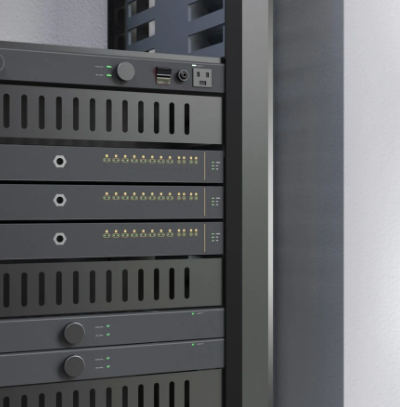 Close-up of a server rack with multiple black electronic devices stacked within a dark gray enclosure.