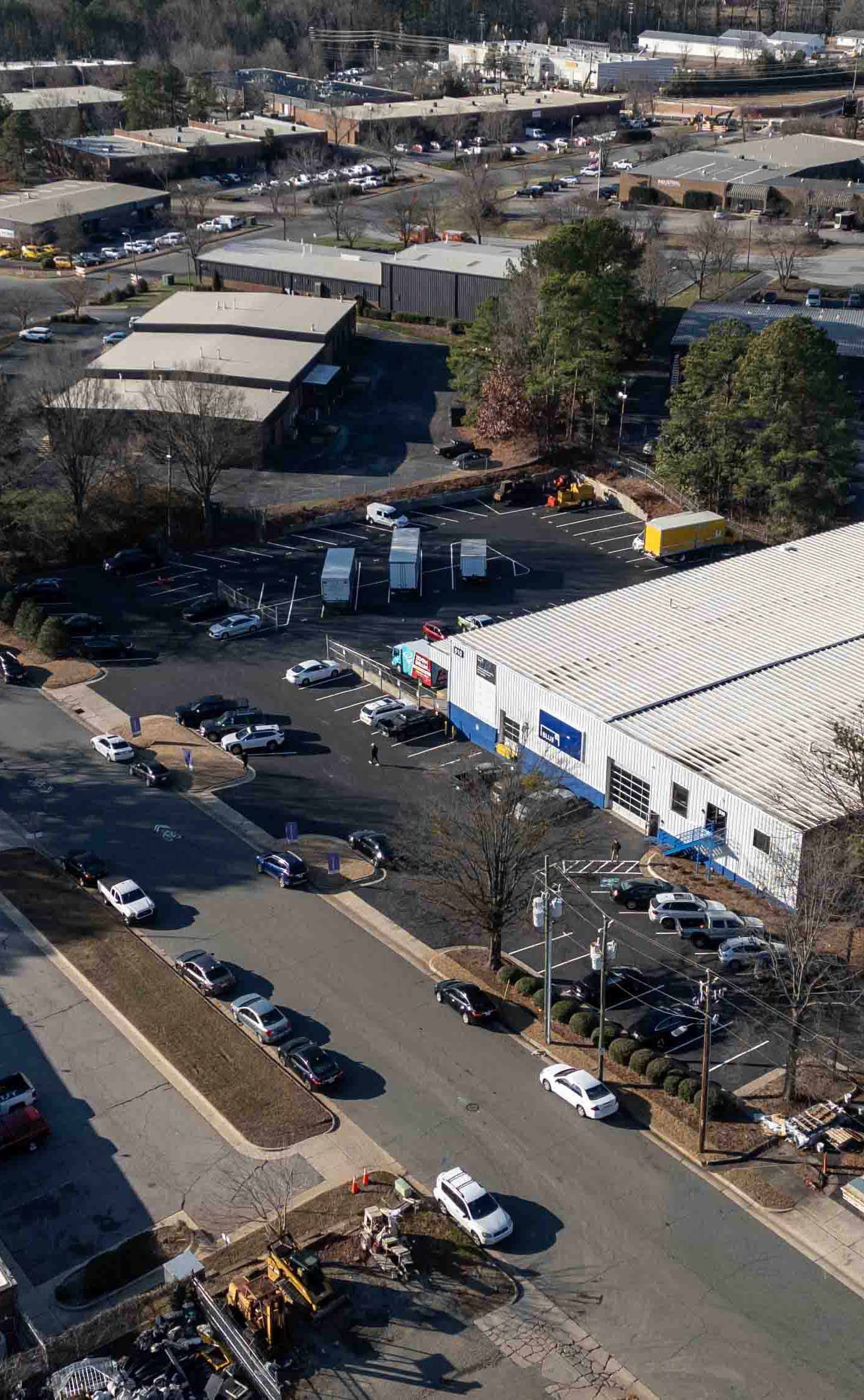 Outdoor patio with pergola, fireplace, and dining table on a sunny day.