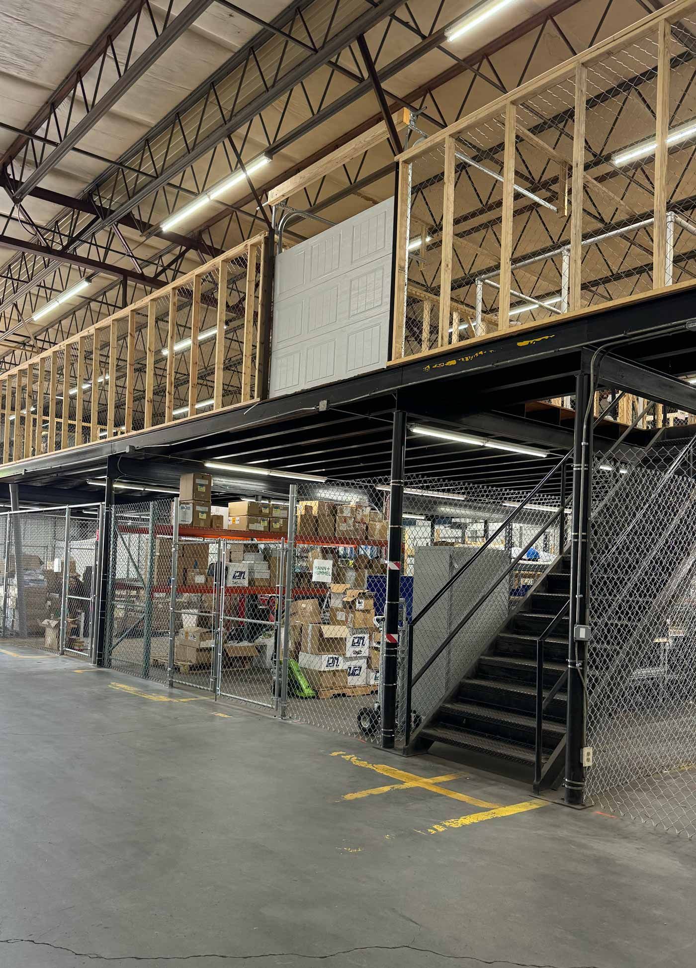 Patio with wicker furniture under a slatted pergola, overlooking a lawn and trees.
