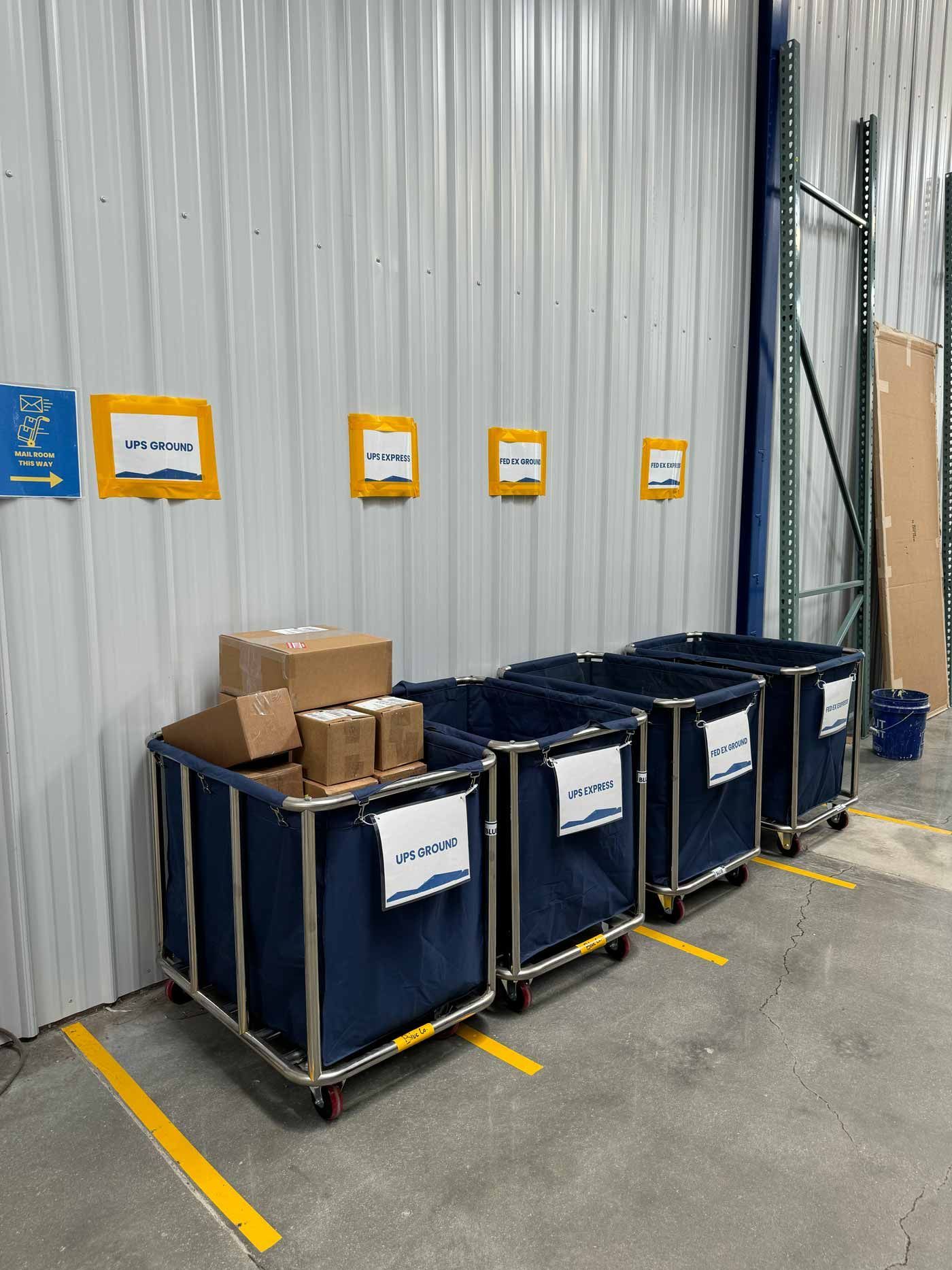 Outdoor patio with seating, kitchen, and TV under a white pergola.