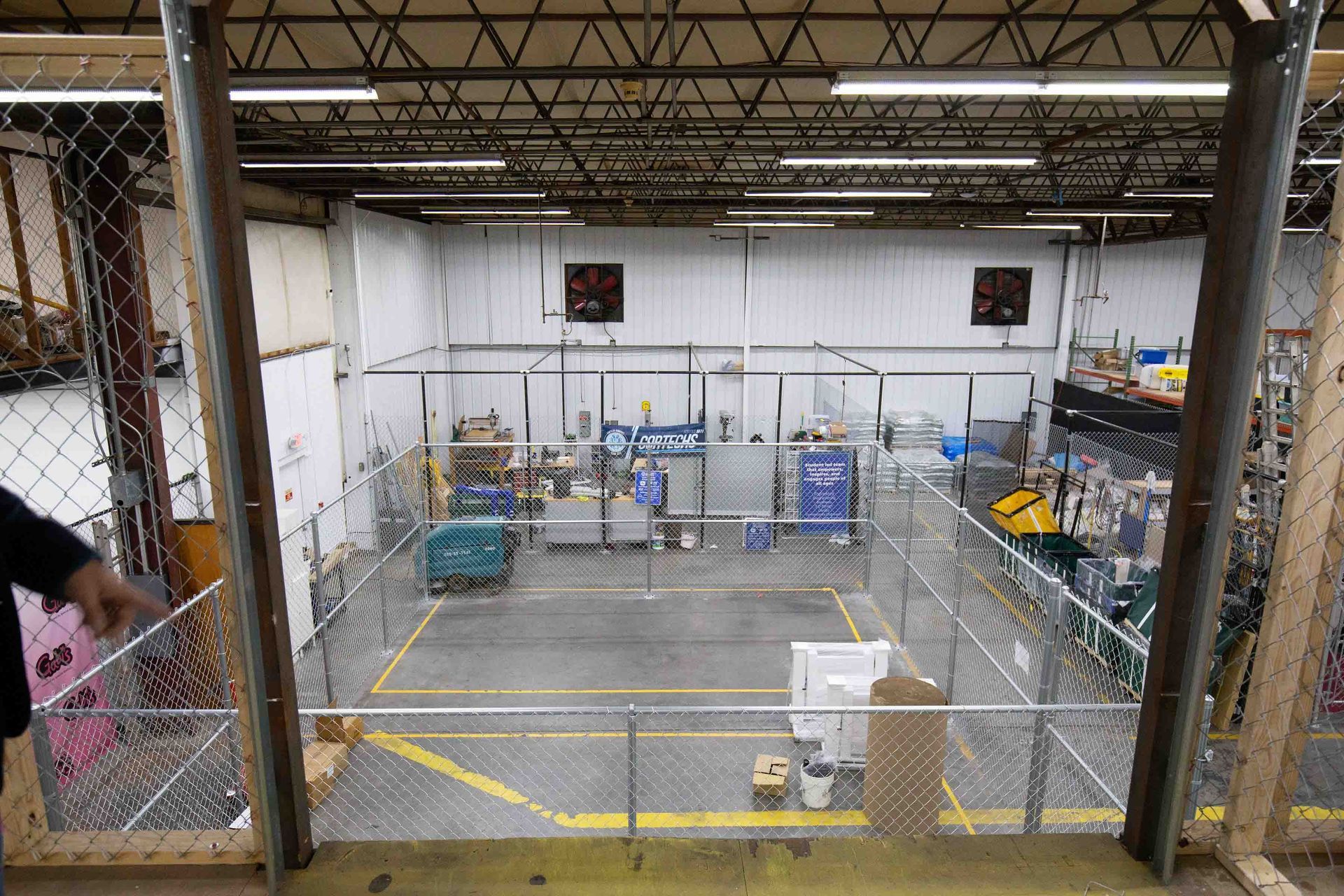Patio with seating under a slatted pergola, overlooking a grassy backyard.