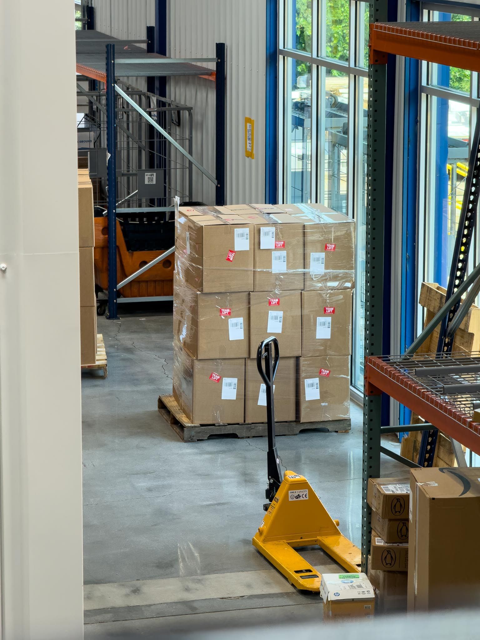 Outdoor patio with pergola, fireplace, and dining table on a sunny day.