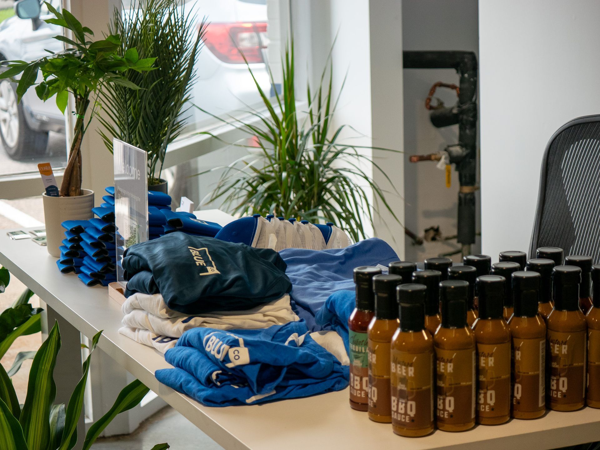 Rooftop outdoor lounge with tables, couches, and overhead canopy, overlooking a city skyline.