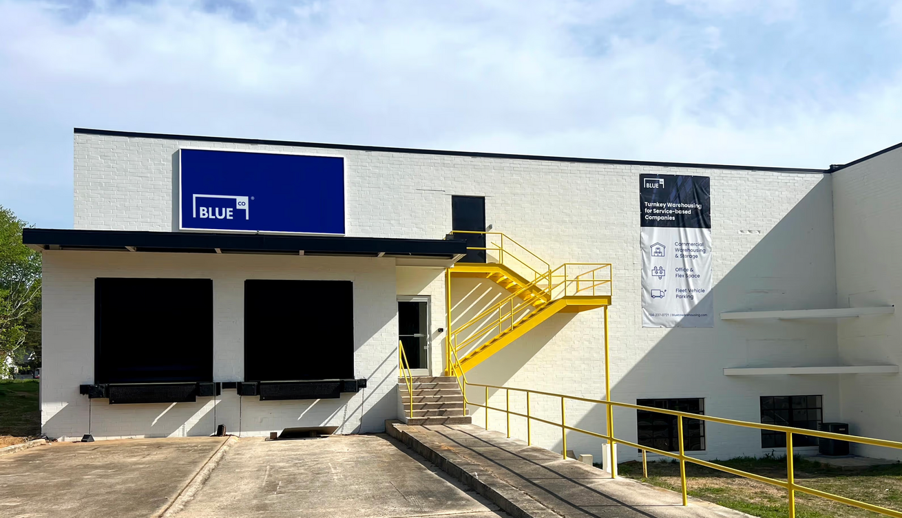 Woman in athletic wear practicing yoga under a modern pergola with a curtain.