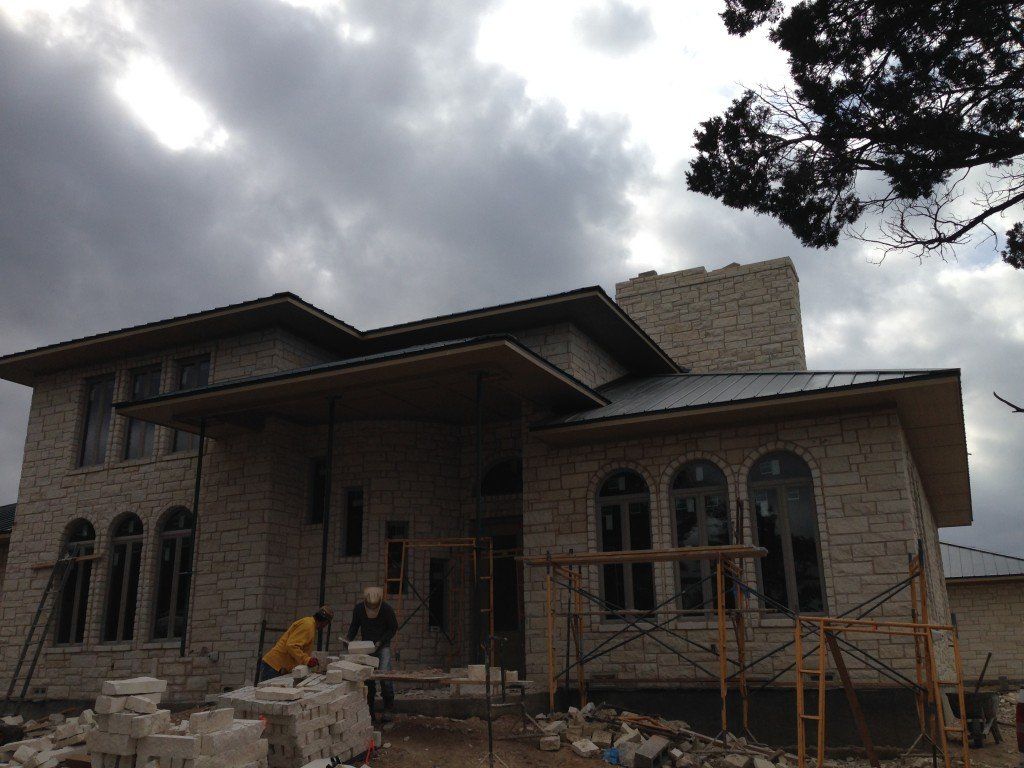 a large stone house is being built with scaffolding around it
