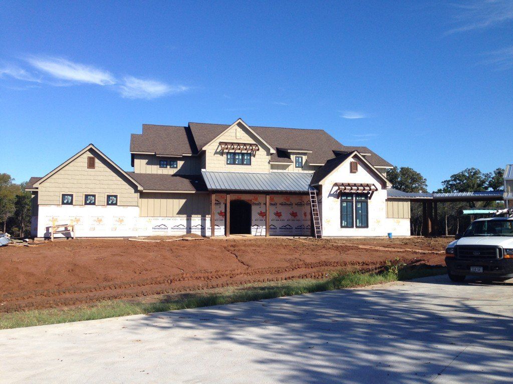 a house that is being built with a truck parked in front of it