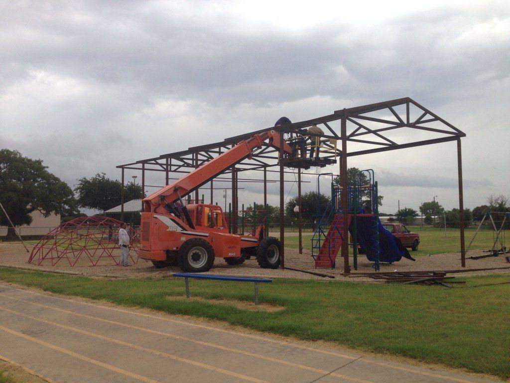 a jlg crane is being used to build a playground