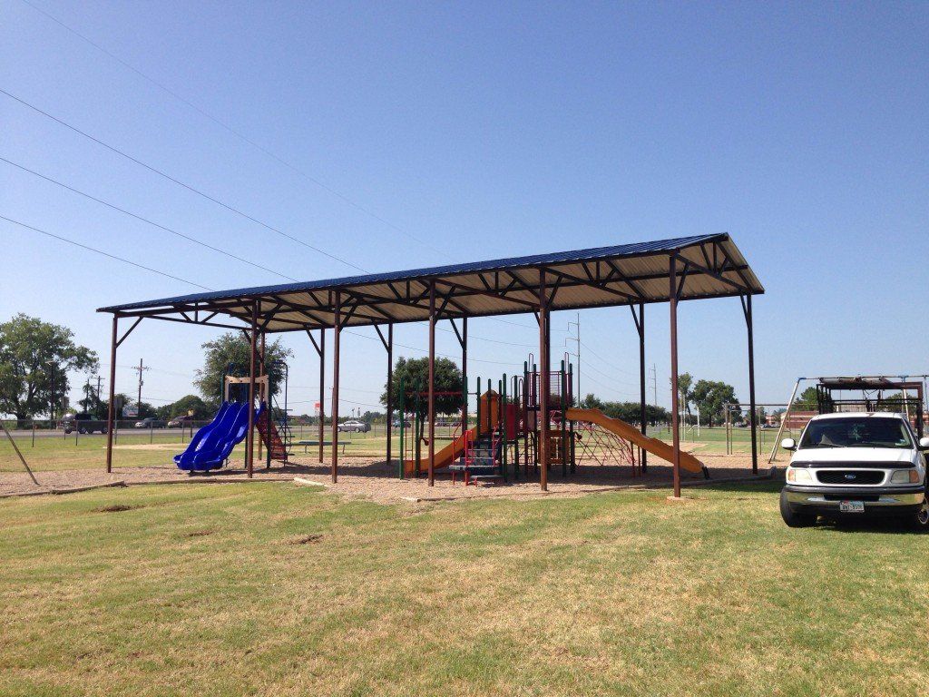 a white ford truck is parked in front of a playground