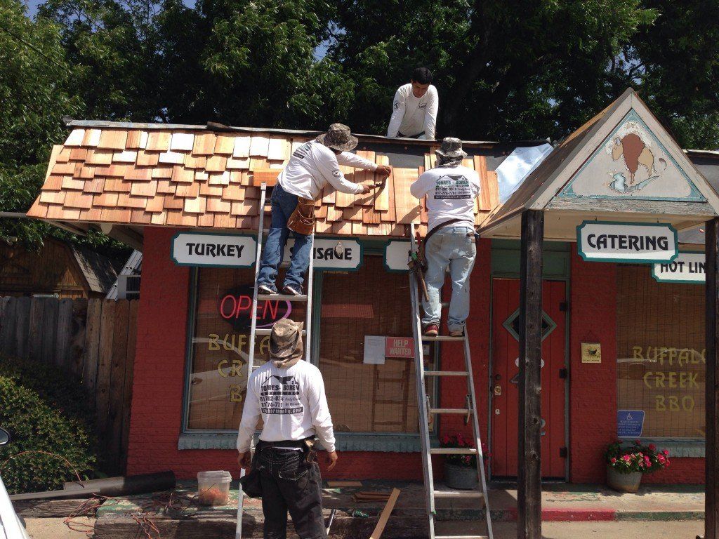 a group of men are working on the roof of a turkey store