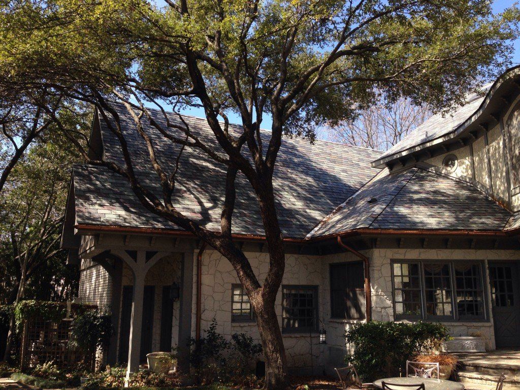a white house with a tree in front of it