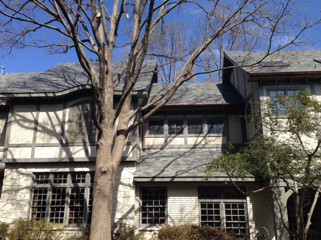 a large house with a tree in front of it