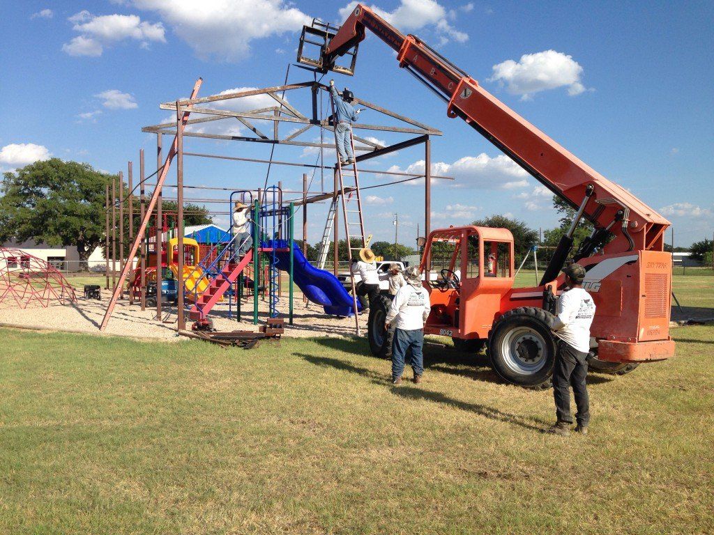 a group of construction workers are working on a playground