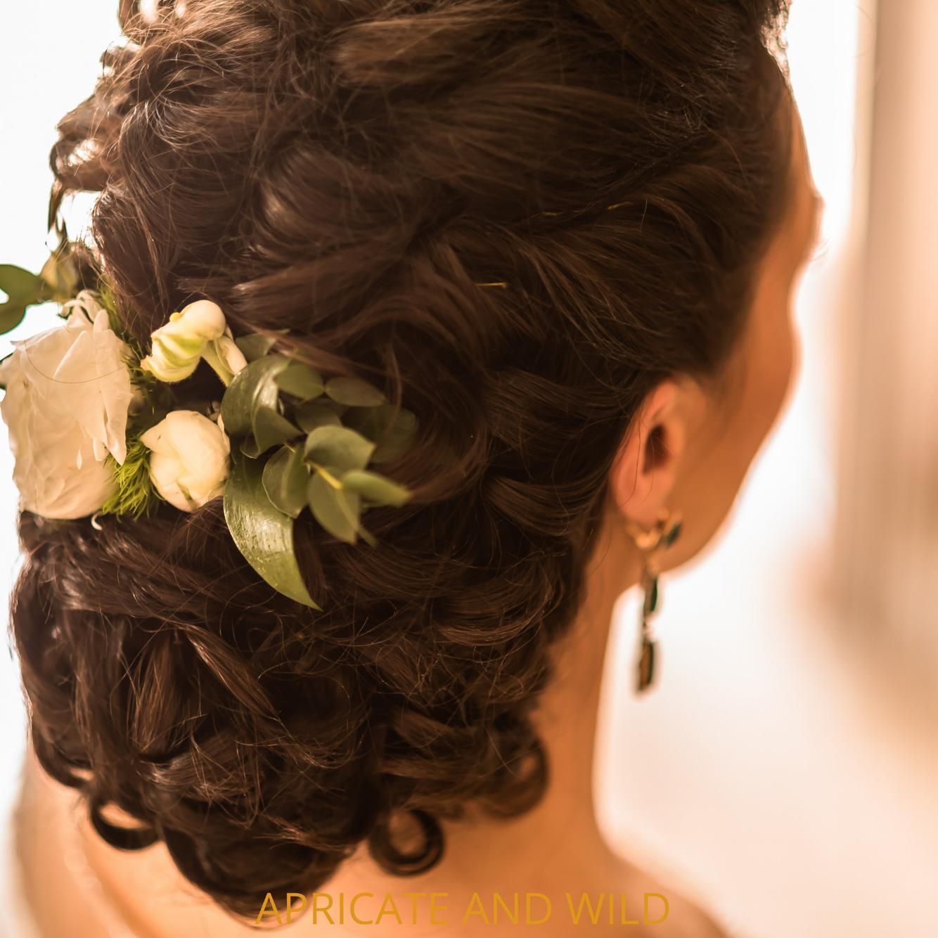 A Woman Wearing a Braided Hairstyle with Flowers in Her Hair β Apricate & Wild Salon in Airlie Beach, QLD