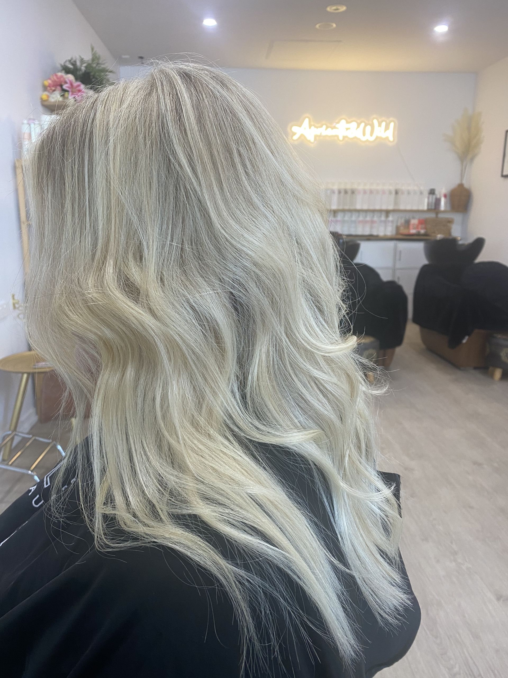 A Woman with Blonde Highlights and Wavy Hair β Apricate & Wild Salon in Airlie Beach, QLD