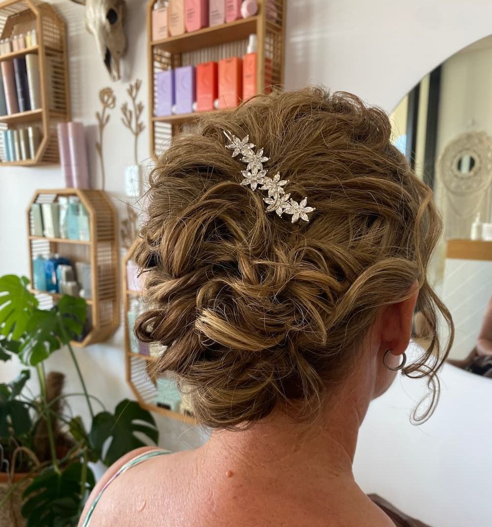A Woman Is Getting Her Hair Done in A Salon — Apricate & Wild Salon in Airlie Beach, QLD
