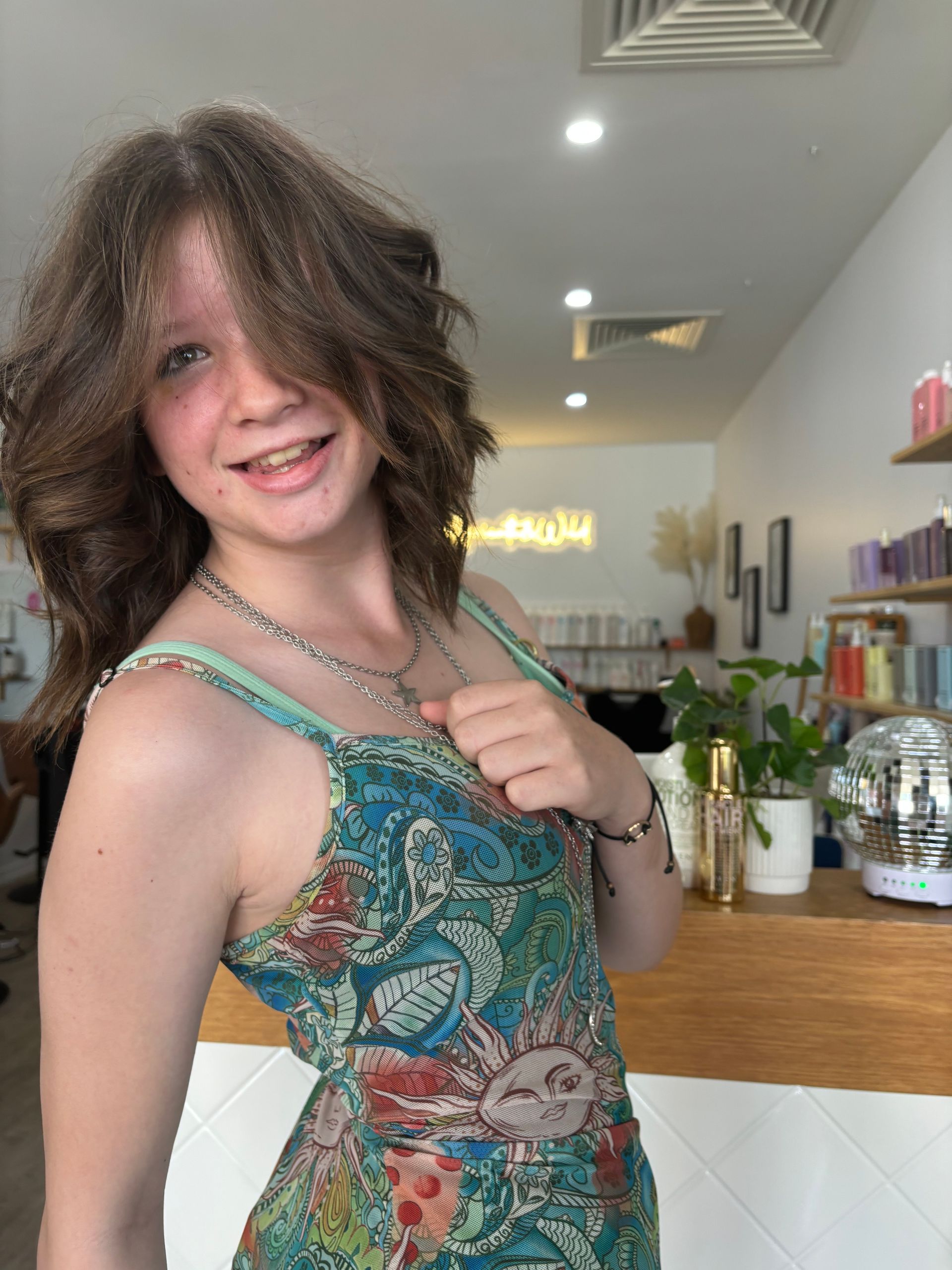 A Woman with Blonde Hair Is Standing in Front of A Shelf β Apricate & Wild Salon in Airlie Beach, QLD