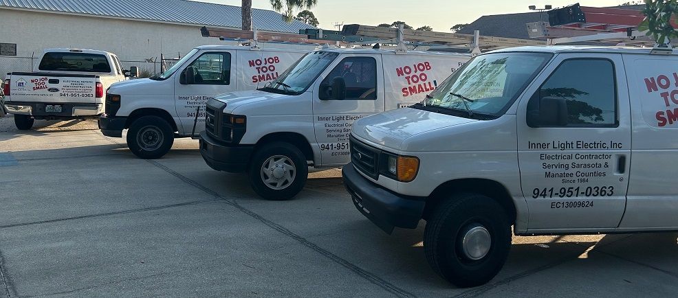 Three white vans are parked next to each other in a parking lot. | Sarasota, FL | Inner Light Electric