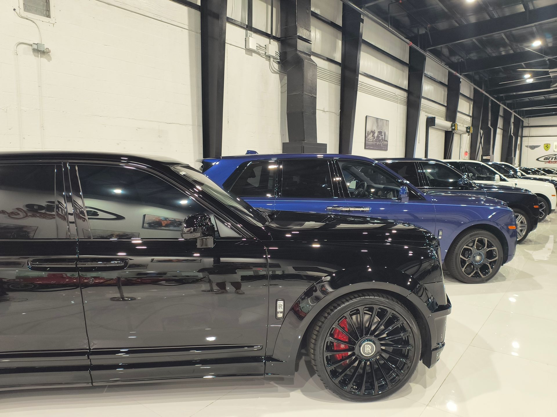 A black mercedes benz g class is parked in a dark parking lot.