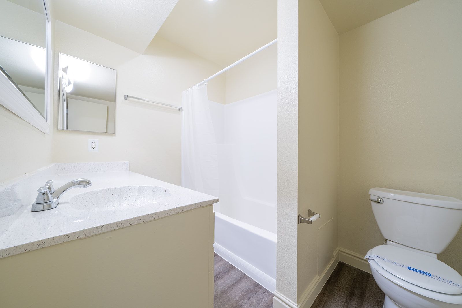 A bathroom with a sink , toilet and bathtub.