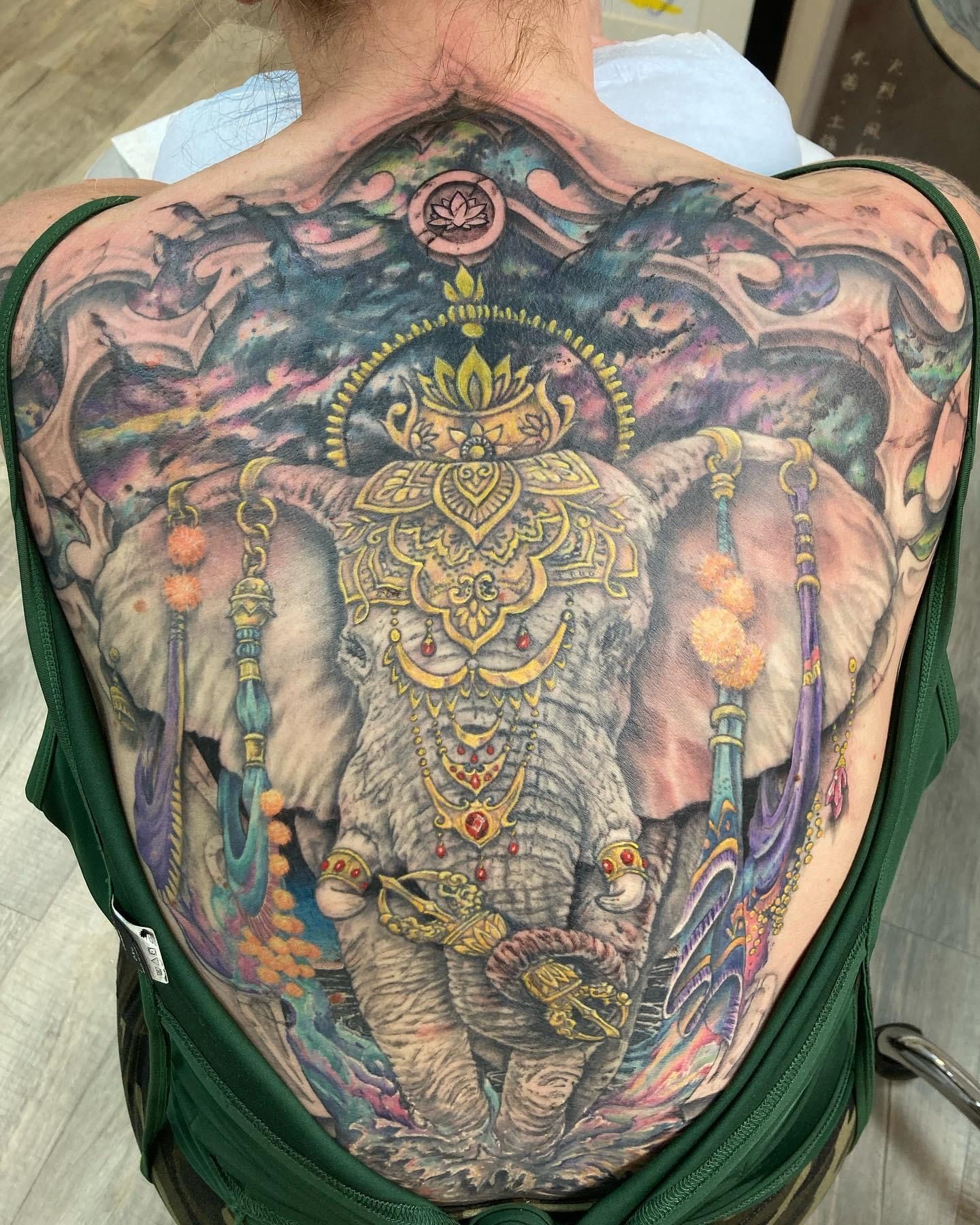 large butterfly with knife in the middle tattoo