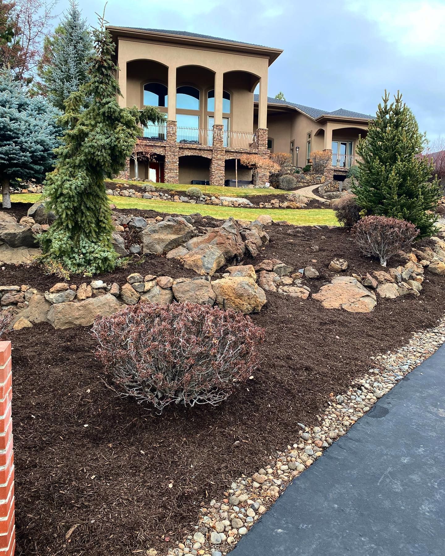 A large house with a lot of rocks in front of it