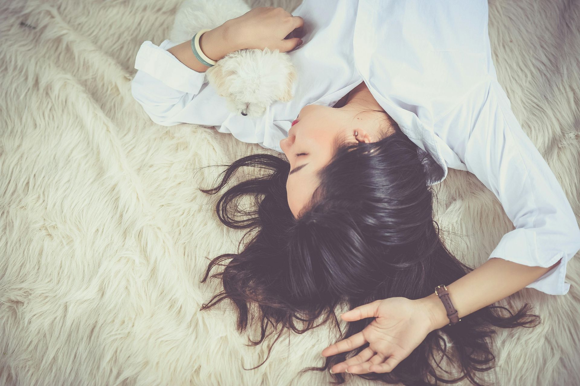 Woman with dark hair sleeping peacefully reflecting calm and deep REM sleep in a blog about women getting quality sleep through perimenopause and menopause.