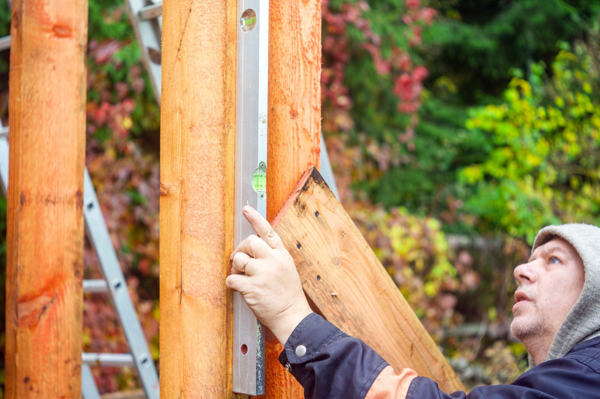 A fence technician from a local fence company installing a residential fence. A fence technician from a local fence company installing a residential fence.