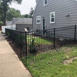 House With A Black Fence In Front Of It — Warren, MI — Kimberly Fence & Supply