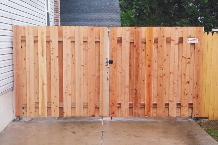 Fence In A Driveway Next To A House — Warren, MI — Kimberly Fence & Supply