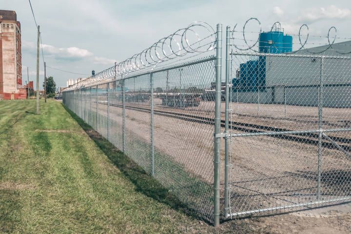 Chain Link Fence With Barbed Wire — Warren, MI — Kimberly Fence & Supply